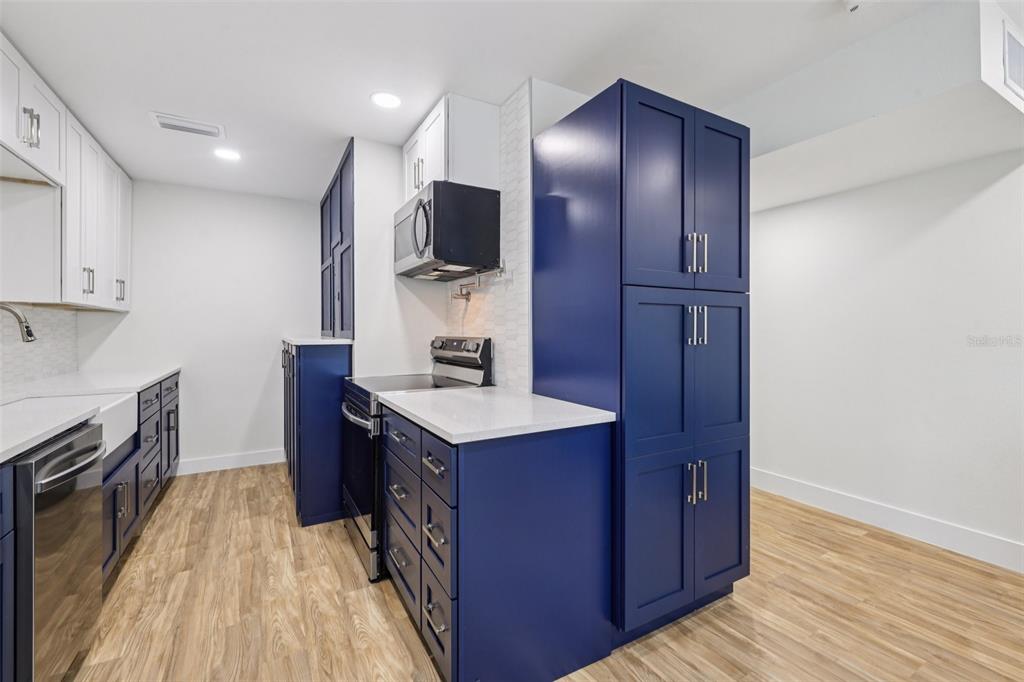 4471 Vieux Carre Circle, Unit 4471 Tampa, FL 33613 - Photo 21 of 58 a kitchen with a sink and wooden cabinets