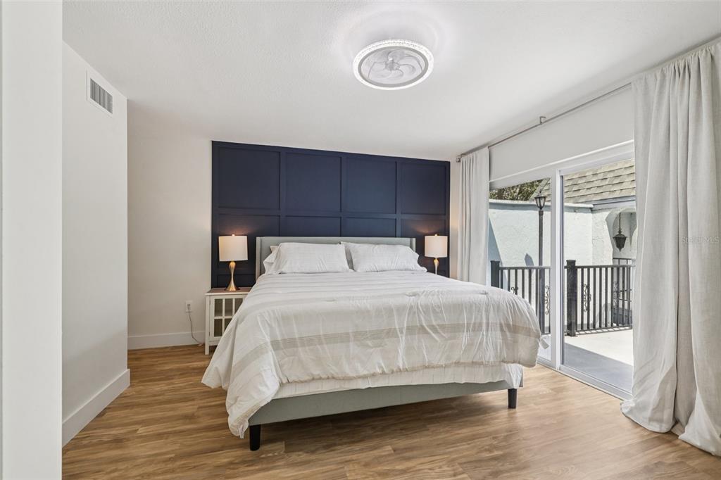 4471 Vieux Carre Circle, Unit 4471 Tampa, FL 33613 - Photo 28 of 58 a bedroom with a bed and wooden floor