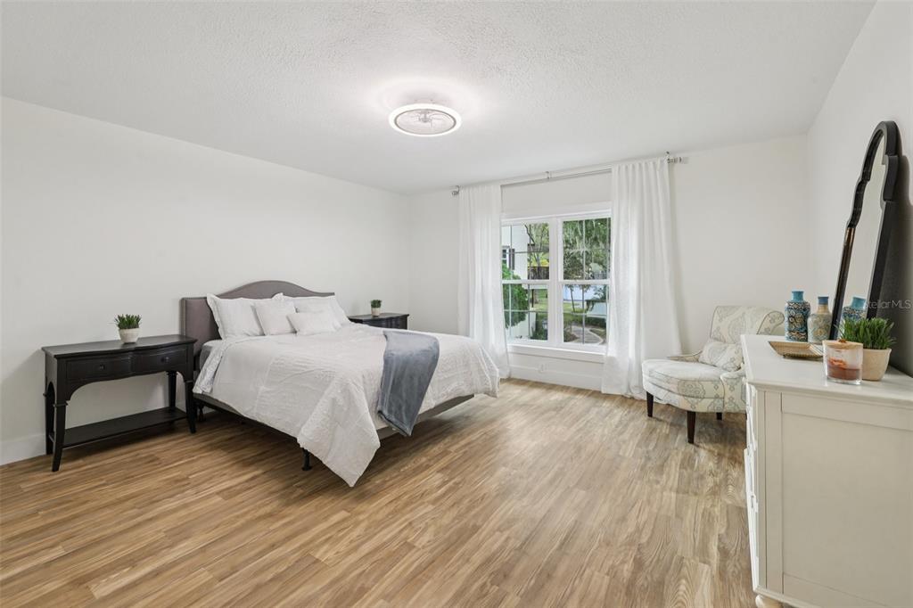 4471 Vieux Carre Circle, Unit 4471 Tampa, FL 33613 - Photo 29 of 58 a bedroom with a bed and a wooden floor