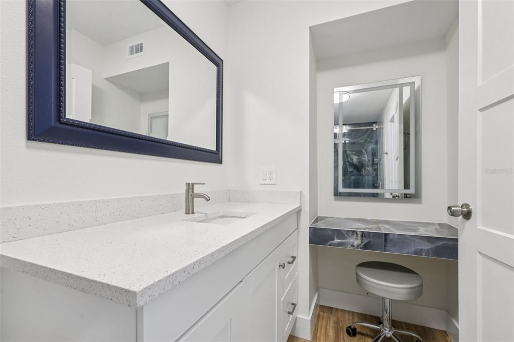 4471 Vieux Carre Circle, Unit 4471 Tampa, FL 33613 - Photo 38 of 58 a bathroom with a sink a mirror and a toilet