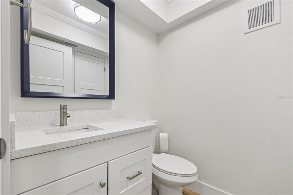 4471 Vieux Carre Circle, Unit 4471 Tampa, FL 33613 - Photo 40 of 58 a bathroom with a toilet a sink and mirror