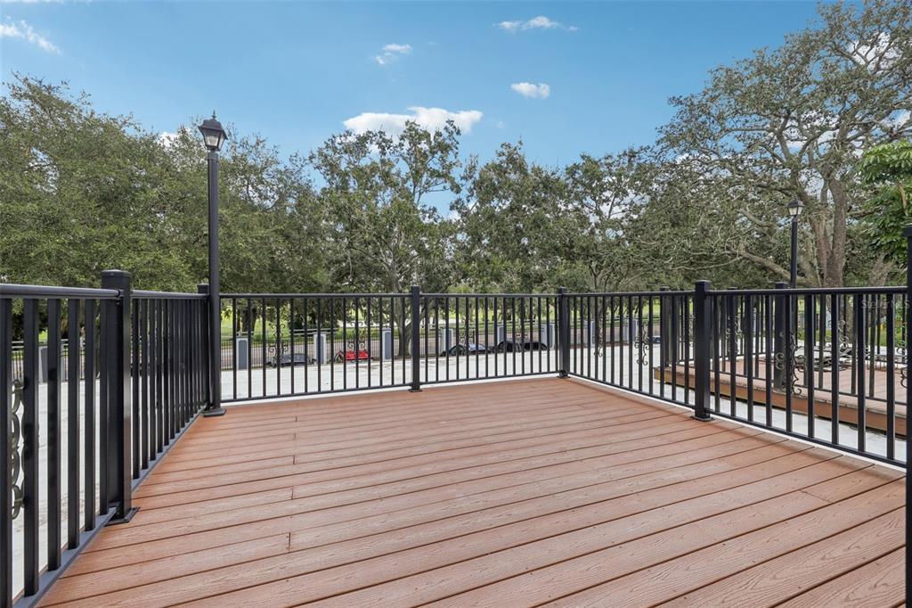 4471 Vieux Carre Circle, Unit 4471 Tampa, FL 33613 - Photo 43 of 58 a balcony with wooden floor and fence