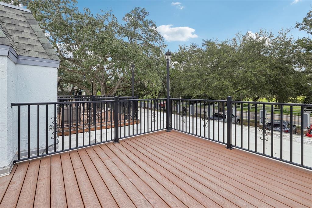 4471 Vieux Carre Circle, Unit 4471 Tampa, FL 33613 - Photo 45 of 58 a balcony with wooden floor and fence
