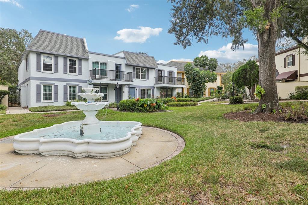 4471 Vieux Carre Circle, Unit 4471 Tampa, FL 33613 - Photo 6 of 58 a view of a white house with a yard and sitting area
