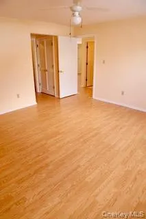 an empty room with closet and windows