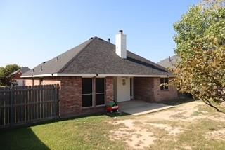 3029 Canary Lane Midlothian, TX 76065 - Photo 20 of 21 Rear view of property featuring a patio area, a chimney, w/ gorgeous tree and brick siding.