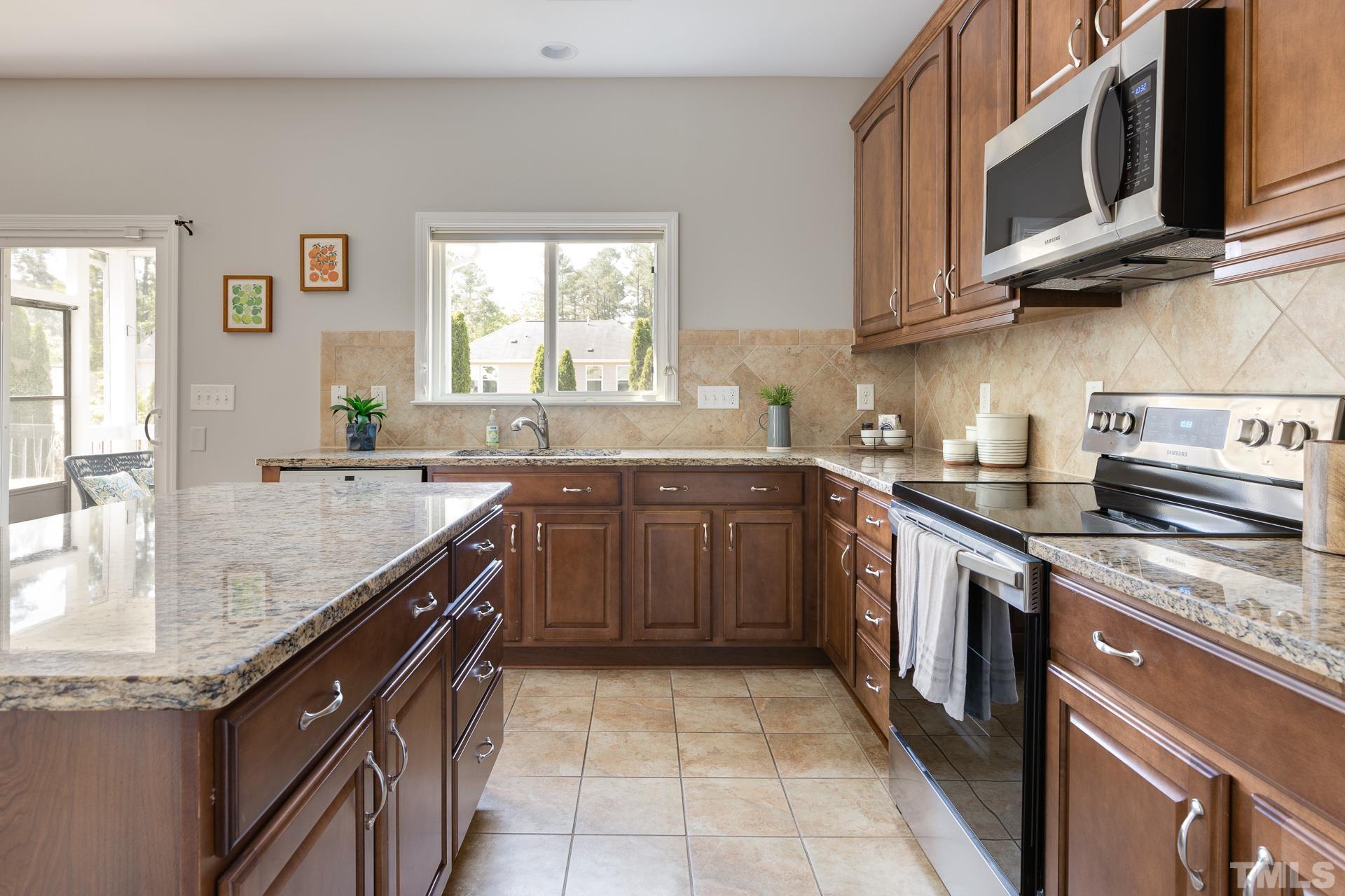 128 Rosaline Lane Durham, NC 27713 - Photo 14 of 31 a kitchen with stainless steel appliances granite countertop a sink stove and cabinets