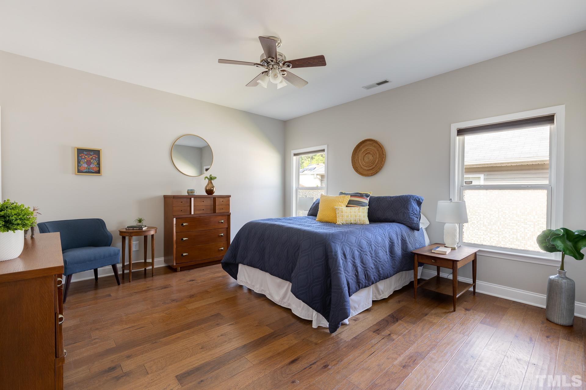 128 Rosaline Lane Durham, NC 27713 - Photo 17 of 31 a bedroom with a bed and a chair
