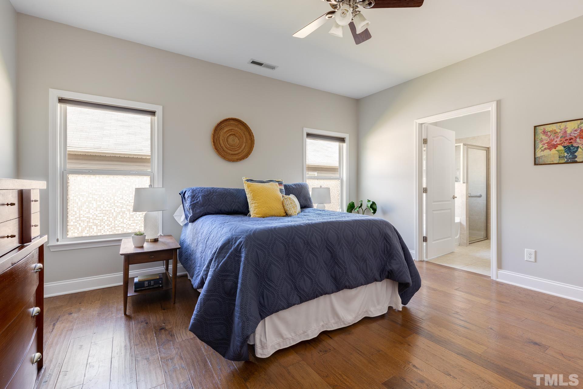 128 Rosaline Lane Durham, NC 27713 - Photo 18 of 31 a spacious bedroom with a bed and a table in it