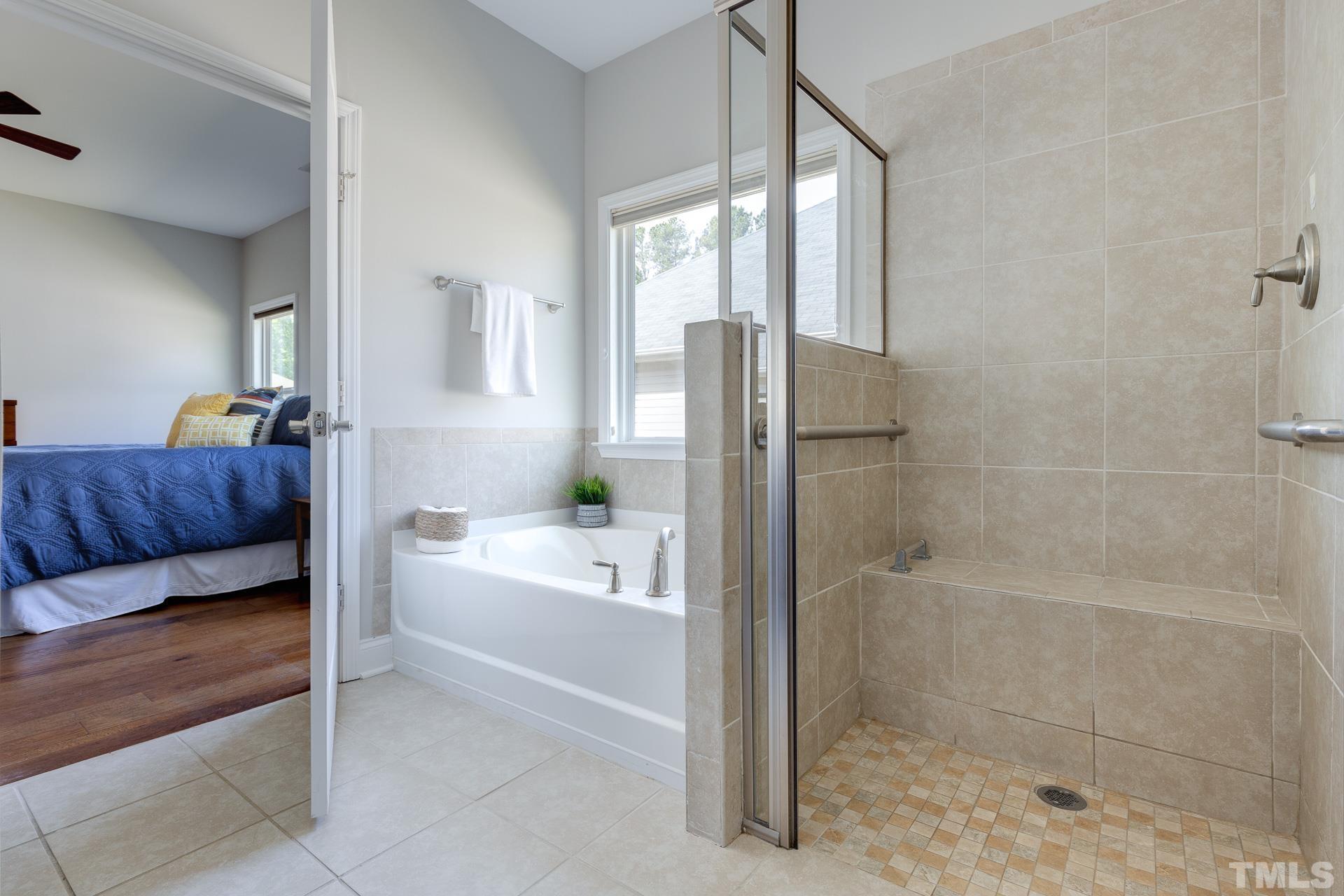 128 Rosaline Lane Durham, NC 27713 - Photo 22 of 31 a spacious bathroom with a bathtub and a shower