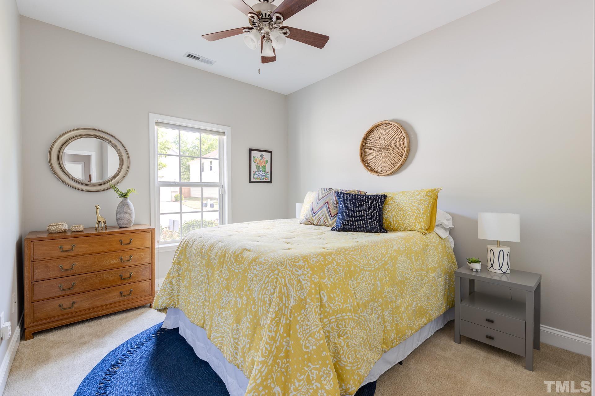 128 Rosaline Lane Durham, NC 27713 - Photo 27 of 31 a bedroom with a bed and a chandelier