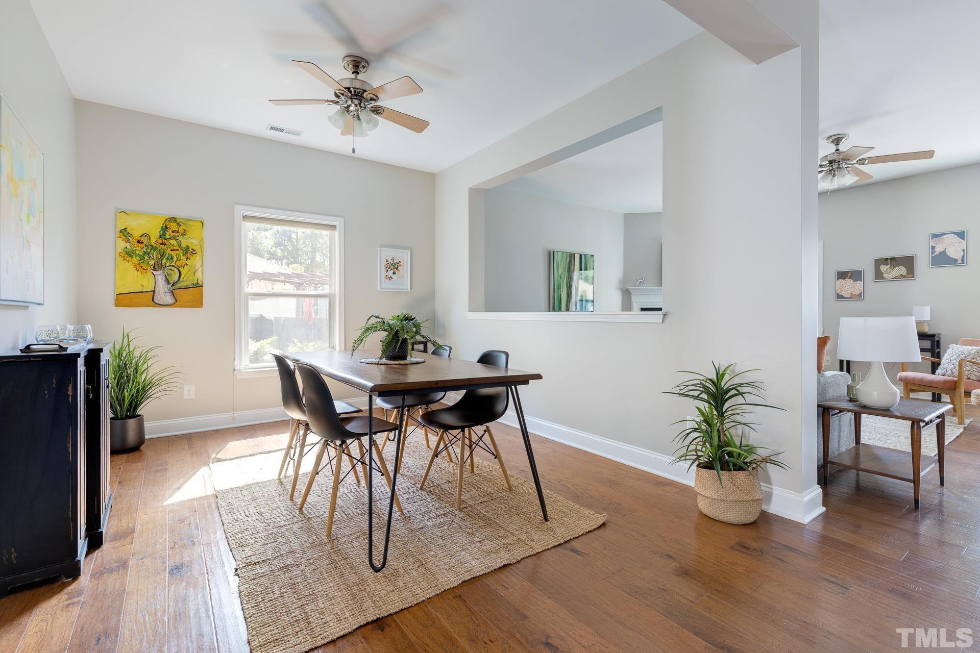 128 Rosaline Lane Durham, NC 27713 - Photo 5 of 31 a dining room with furniture potted plants and wooden floor