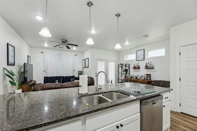 a view of a house with a yard and wooden fence