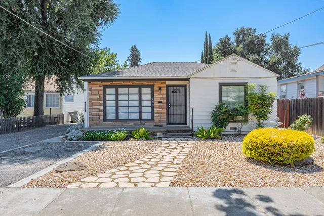 a front view of a house with garden