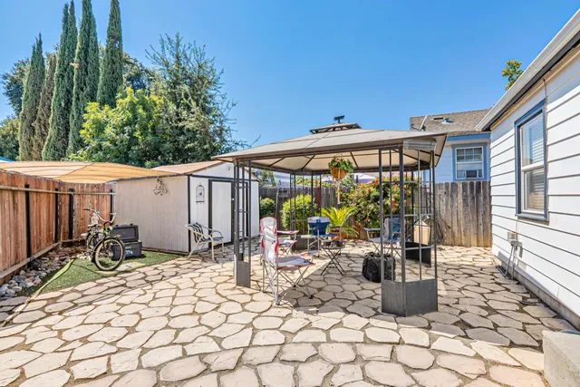 a view of house with patio outdoor seating and covered with couches