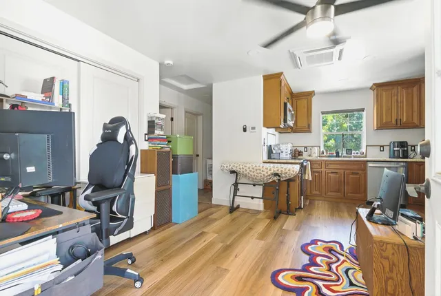a living room with furniture and a wooden floor