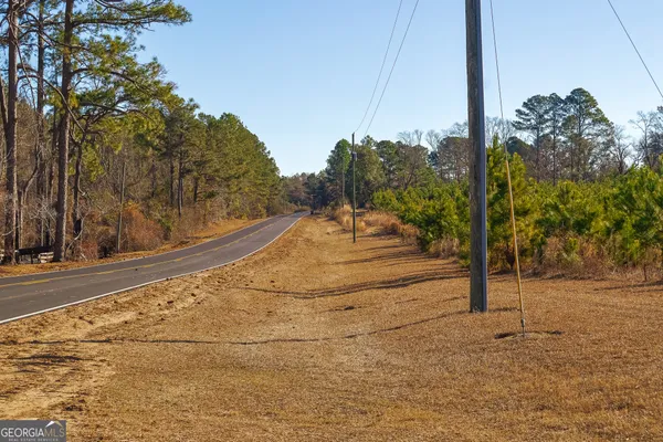 a view of a road with a building in the background