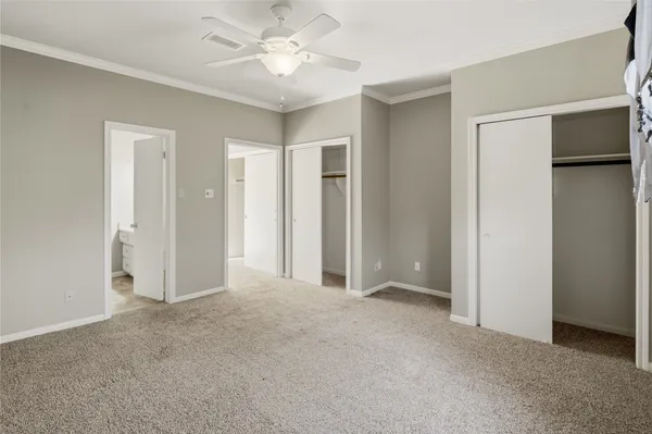 a view of a big room with wooden floor and windows
