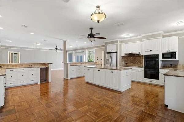 a kitchen with stainless steel appliances granite countertop a sink and cabinets