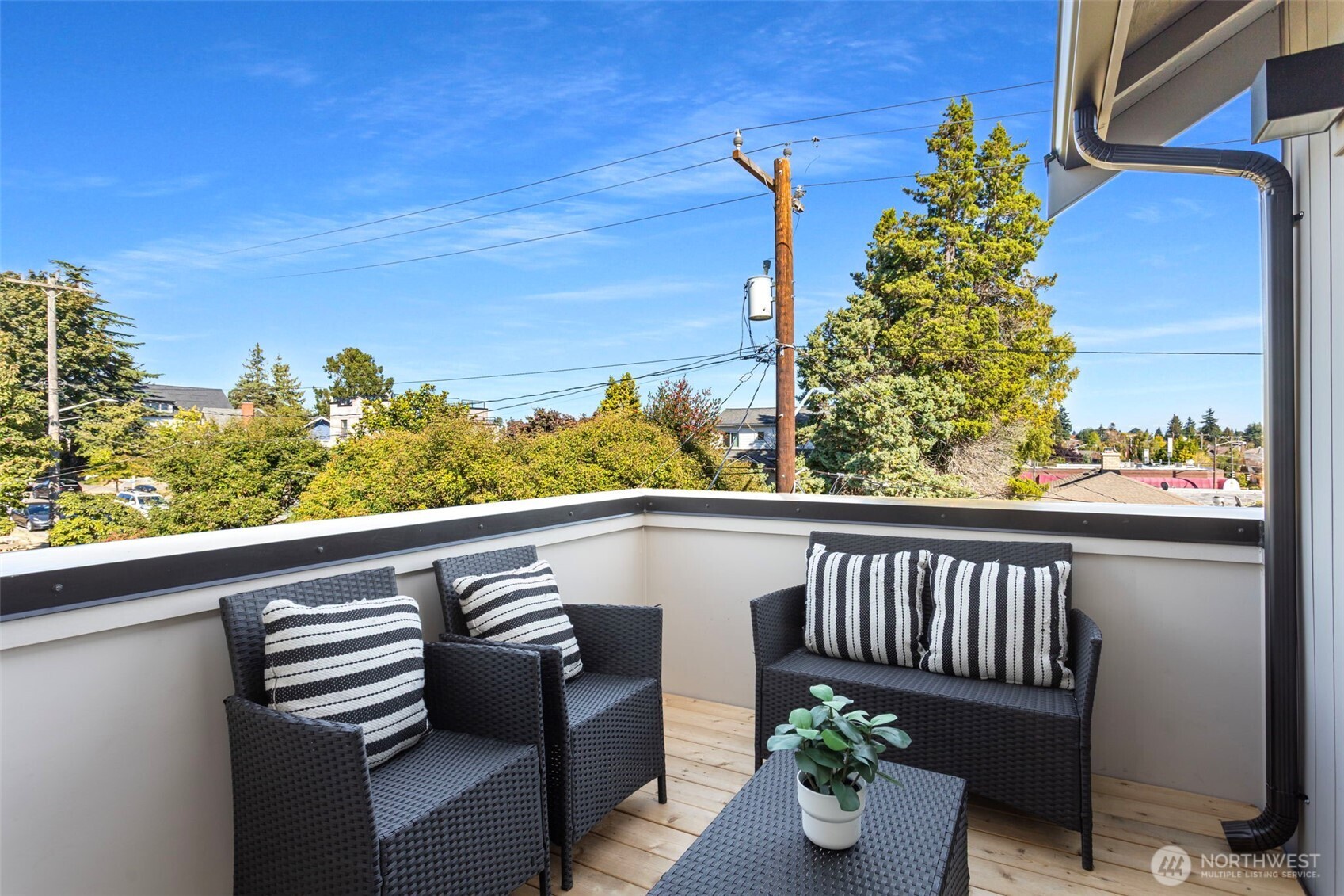 8007 25th Avenue Northwest Seattle, WA 98117 - Photo 30 of 31 a view of a balcony with chair and potted plants