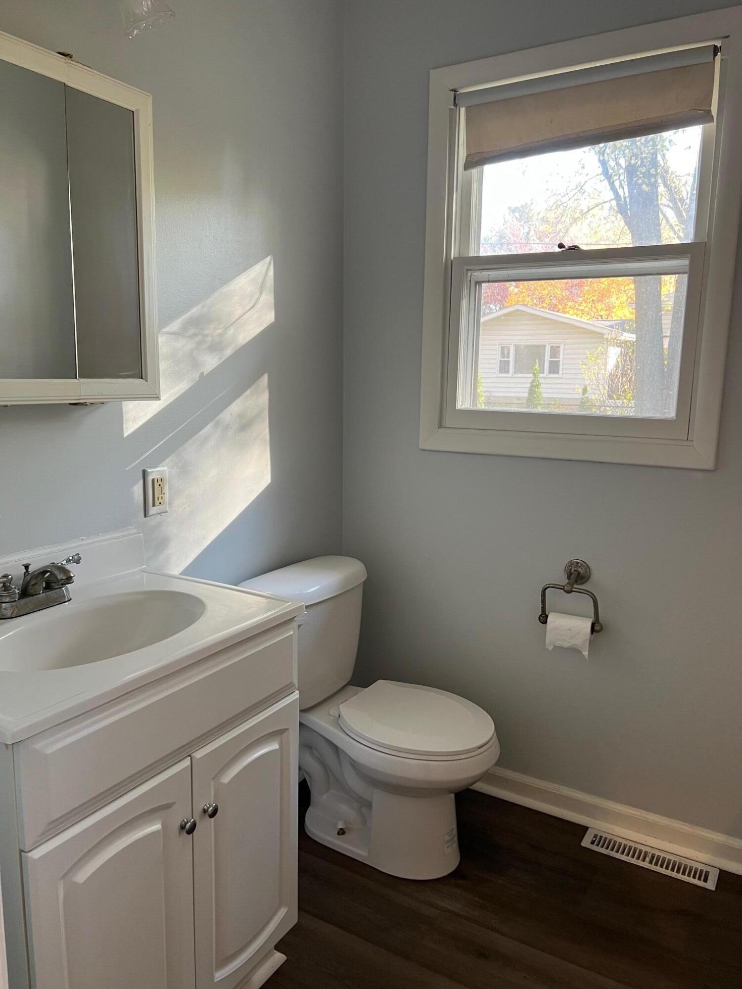 655 Gene Lane Valparaiso, IN 46385 - Photo 11 of 21 a bathroom with a toilet a sink and a window