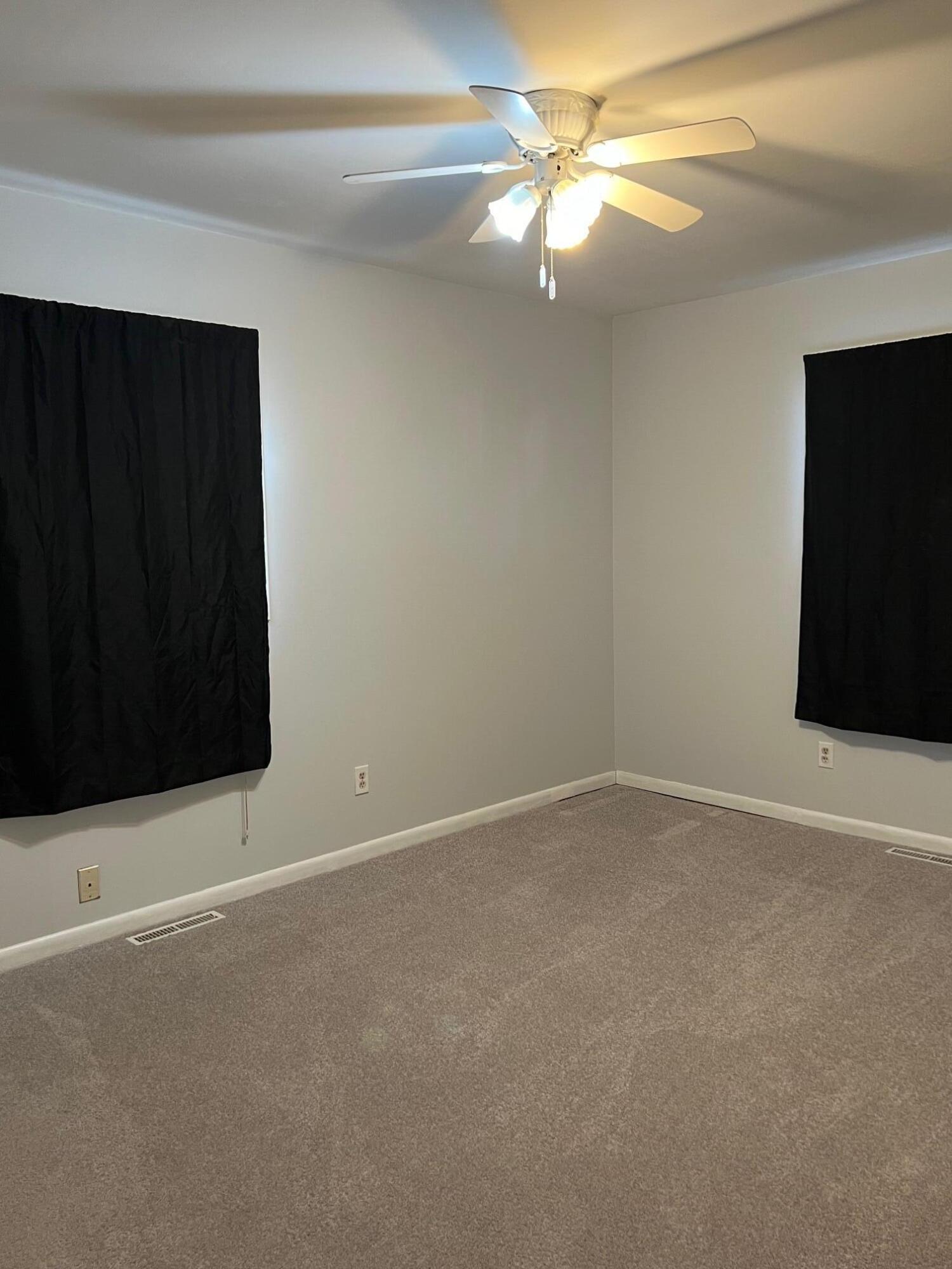 655 Gene Lane Valparaiso, IN 46385 - Photo 17 of 21 a view of an empty room with a ceiling fan and a window