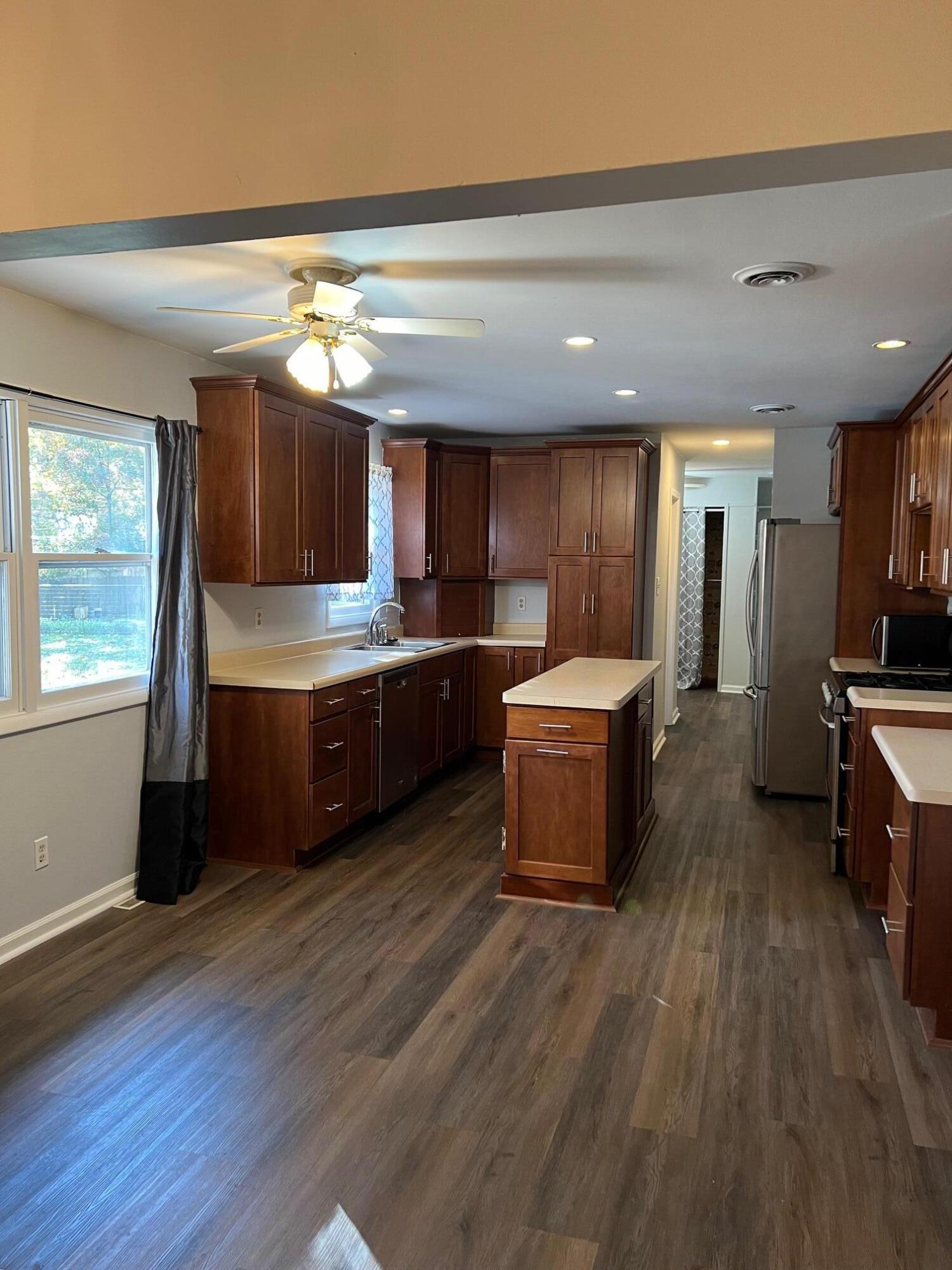 655 Gene Lane Valparaiso, IN 46385 - Photo 5 of 21 a kitchen with stainless steel appliances wooden floors and wooden cabinets