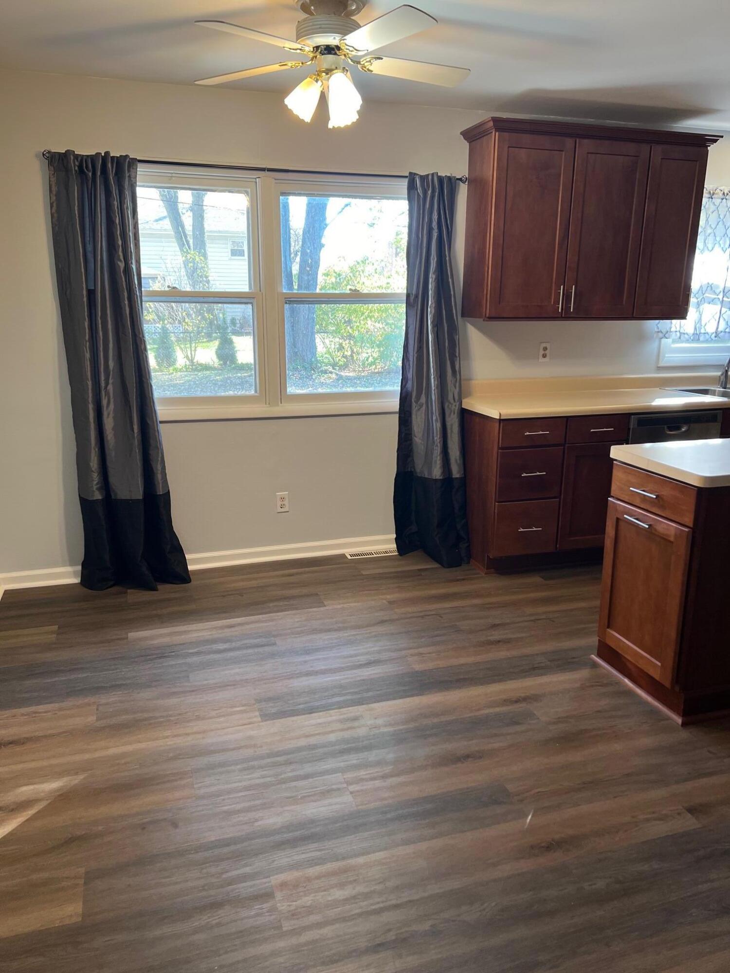 655 Gene Lane Valparaiso, IN 46385 - Photo 6 of 21 a kitchen with wooden floors and wooden cabinets