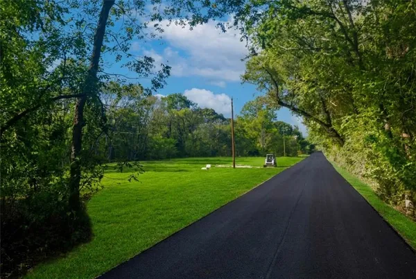 a view of a street with a yard