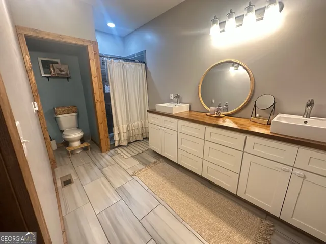 a spacious bathroom with a double vanity sink and a mirror