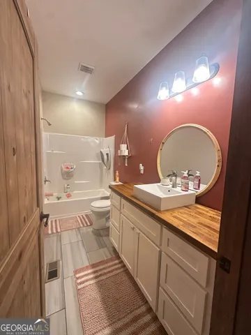 a large bathroom with a sink a large mirror and vanity