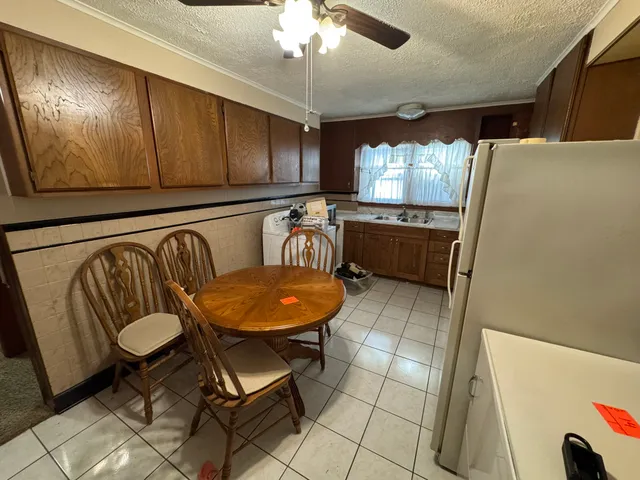 a kitchen with stainless steel appliances a refrigerator a microwave a sink and a stove