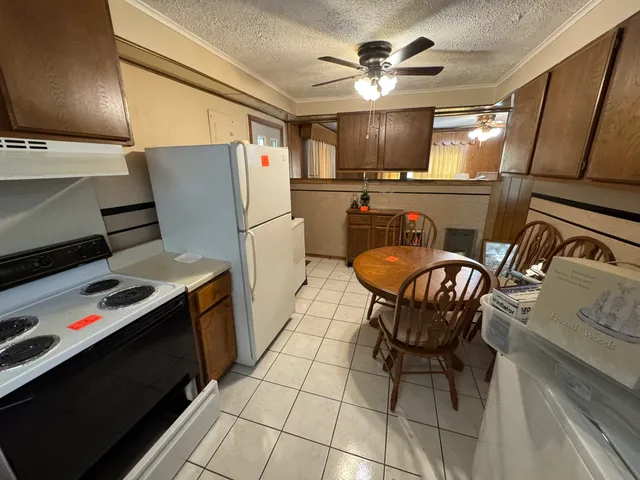 a bedroom with bed and a chandelier