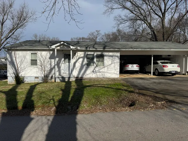 a view of a car park in front of house