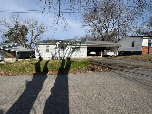 a view of a house with a yard and garage