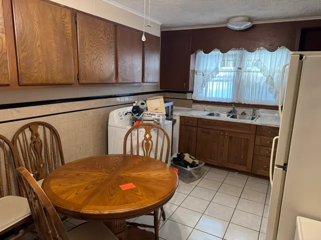 a bathroom with a sink mirror and window