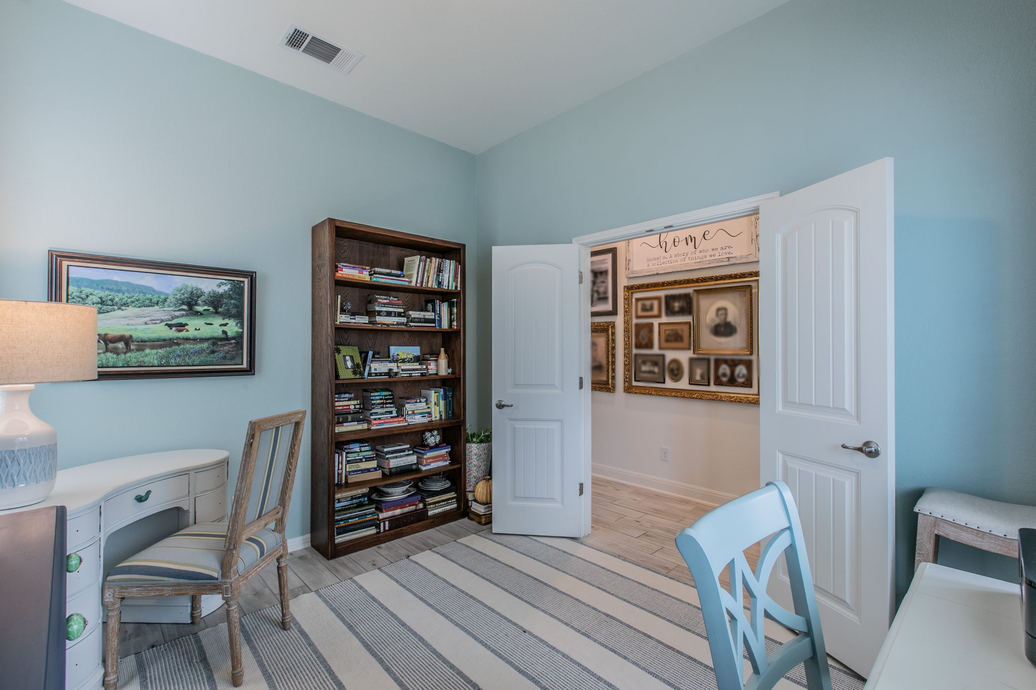 231 Simon Kyle, TX 78640 - Photo 22 of 29 Interior room featuring light blue walls, wood-finish flooring, and white trim