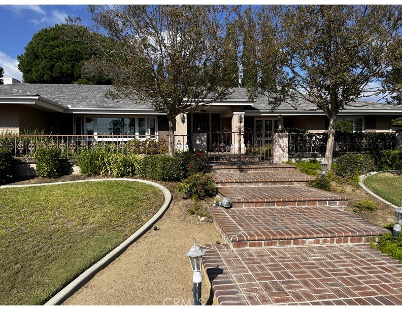 a front view of a house with garden
