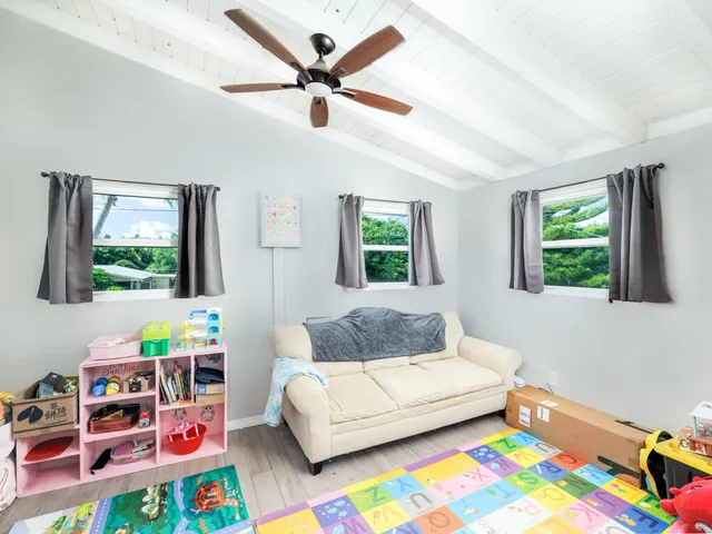 a living room with toys and a baby crib