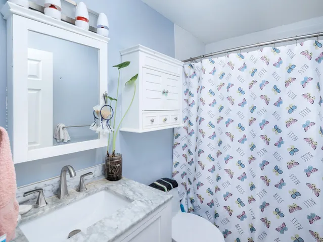 a bathroom with a sink toilet and shower