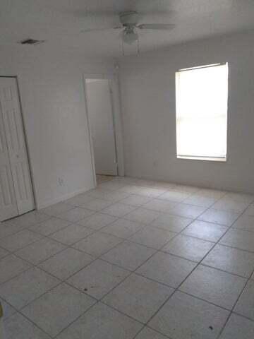 1201 West 32nd Street Riviera Beach, FL 33404 - Photo 8 of 9 an empty room with a window