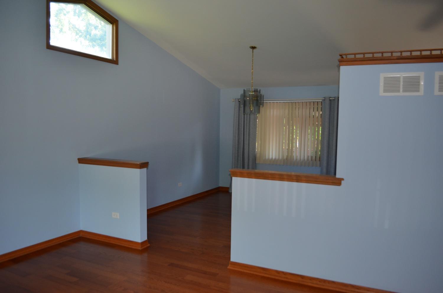 2330 Boulder Road Dyer, IN 46311 - Photo 7 of 24 an empty room with wooden floor and windows