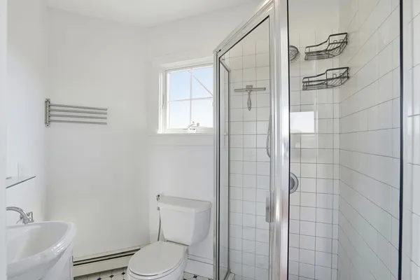 a bathroom with a toilet and shower