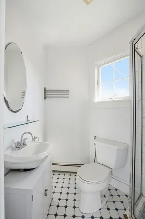 a bathroom with a sink a toilet and a mirror