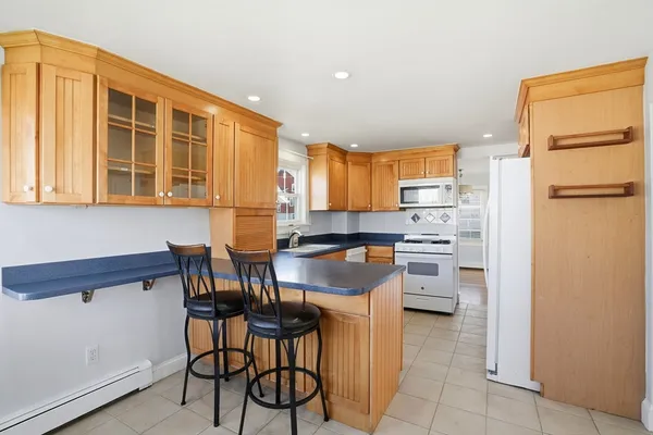 a kitchen with stainless steel appliances kitchen island granite countertop a refrigerator and a stove top oven