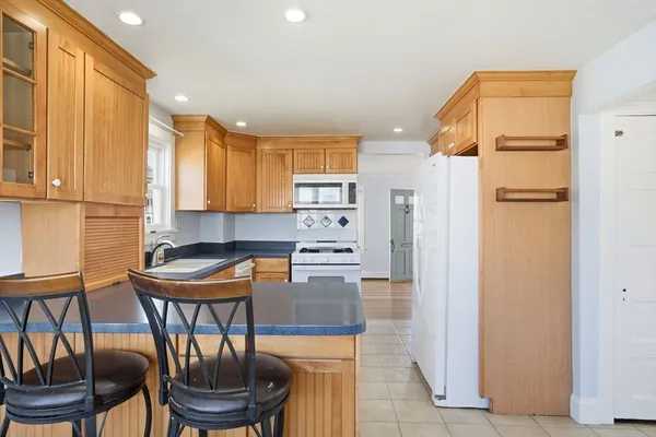 a kitchen with a refrigerator and more cabinets