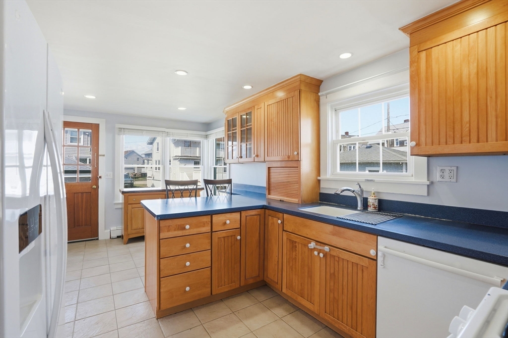 7 Mildred Street Hull, MA 02045 - Photo 17 of 42 a kitchen with stainless steel appliances granite countertop a sink and cabinets