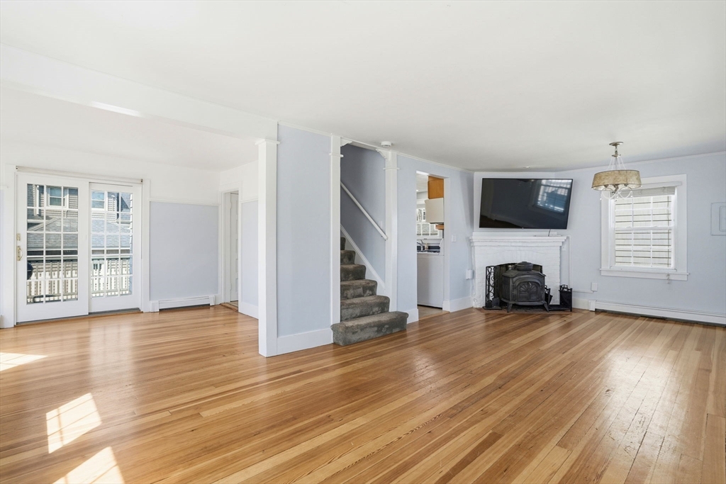 7 Mildred Street Hull, MA 02045 - Photo 20 of 42 a view of a livingroom with wooden floor a fireplace and window