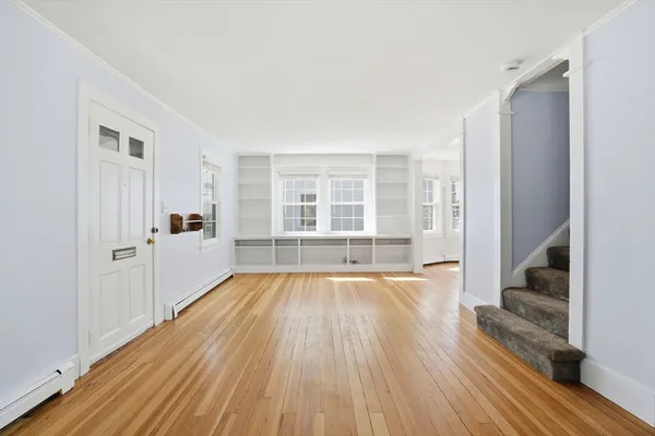 wooden floor in an empty room with a window