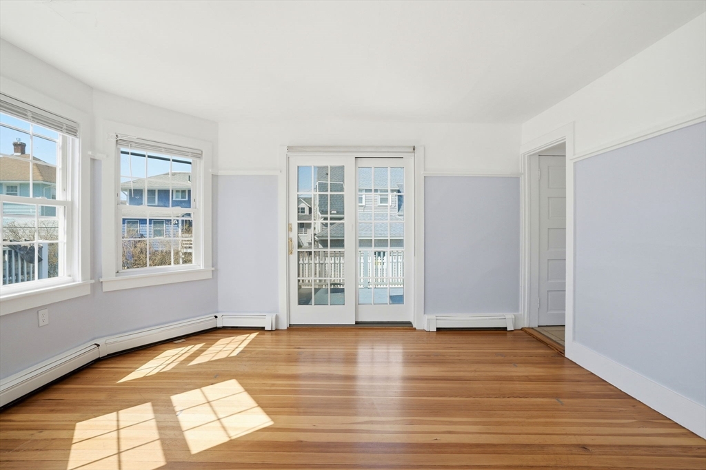 7 Mildred Street Hull, MA 02045 - Photo 23 of 42 an empty room with wooden floor and windows
